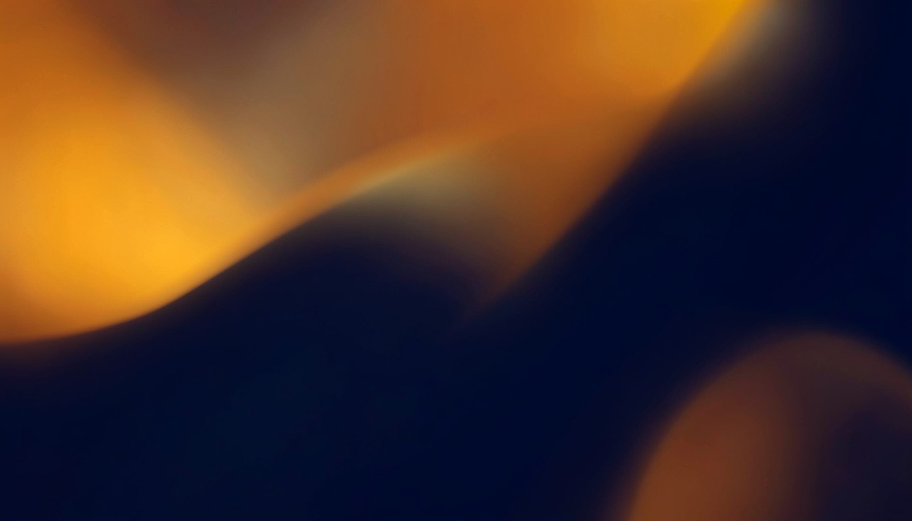 Warm amber and deep navy abstract backdrop with soft glowing highlights, evoking a sense of community gathering and shared purpose